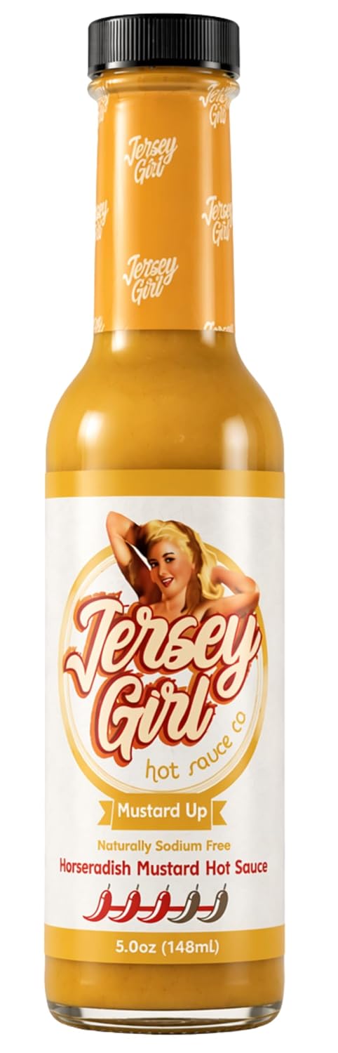 A bottle of Jersey Girl Hot Sauce, specifically the 'Mustard Up' horseradish mustard sauce. The bottle is filled with a golden-yellow sauce and features a retro-style white label with an illustration of a woman and the brand name 'Jersey Girl'.