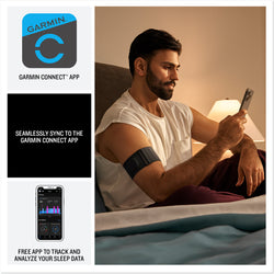 A man sits on a bed at night, wearing a Garmin armband device and looking at his smartphone. The image highlights syncing with the Garmin Connect app, which tracks and analyzes sleep data. Also shown are the Garmin Connect logo, a sample app screen with sleep metrics, and text stating “Seamlessly sync to the Garmin Connect app” and “Free app to track and analyze your sleep data.”
