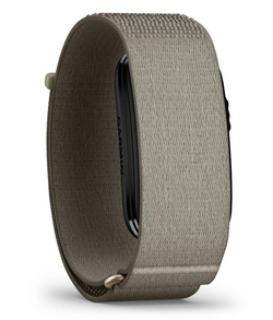 A close-up of a Garmin smartwatch band in a textured taupe-gray fabric, showing the inner black screen area and the fabric strap details against a white background.