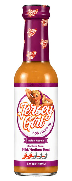 A bottle of Jersey Girl Indian Masala hot sauce on a plain white background. The bottle contains orange-red sauce and features a white label with purple accents and a retro pin-up girl illustration.